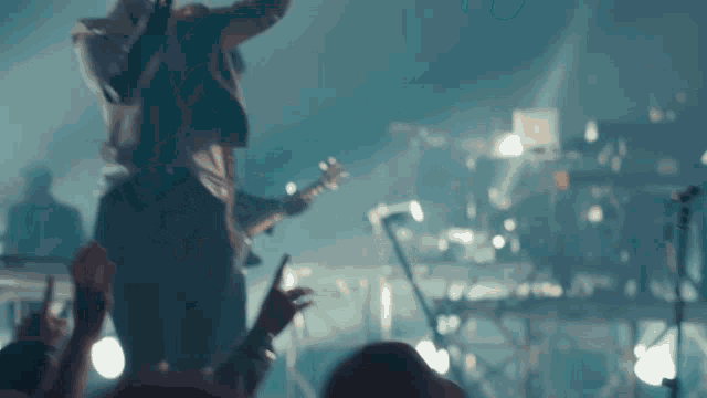 a man is singing into a microphone while playing a guitar