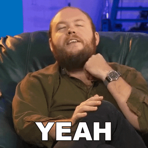 a man with a beard is sitting in a chair with his eyes closed and the word yeah above him