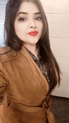 a woman wearing a brown coat and red lipstick