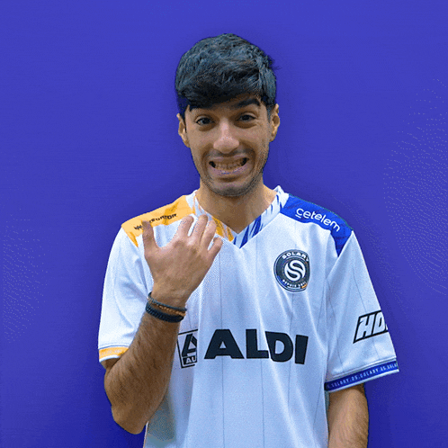 a man wearing a white shirt that says aldi on the front