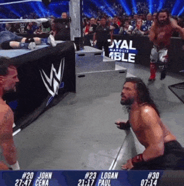 a wrestling match between john cena and logan paul is being shown on a screen