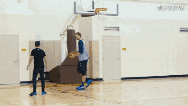 a basketball player wearing a dallas jersey talks to another player