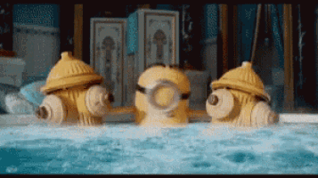 three yellow fire hydrants are floating in a pool of water