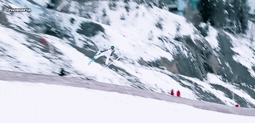 a person is skiing down a snow covered slope and the words lewanaria are on the bottom of the screen
