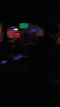 a blurry picture of a dark room with a few lights