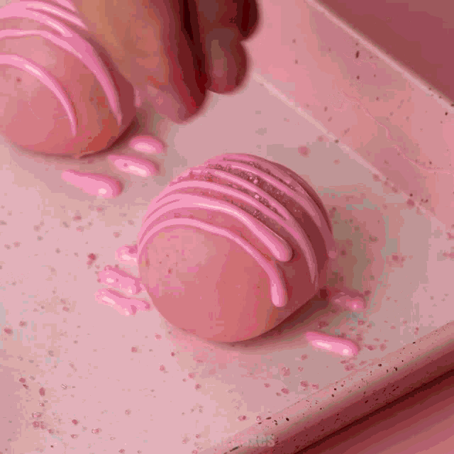 a heart shaped box filled with pink and white truffles