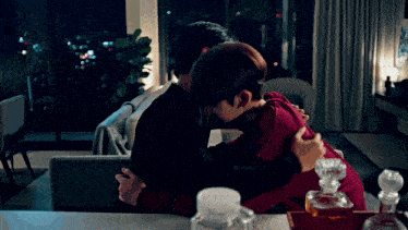 a man and woman hugging in a living room