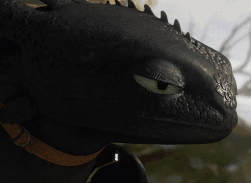 a close up of a black dragon 's face with horns