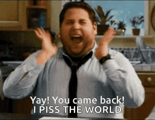 a man in a tie says yay you came back i piss the world in a kitchen