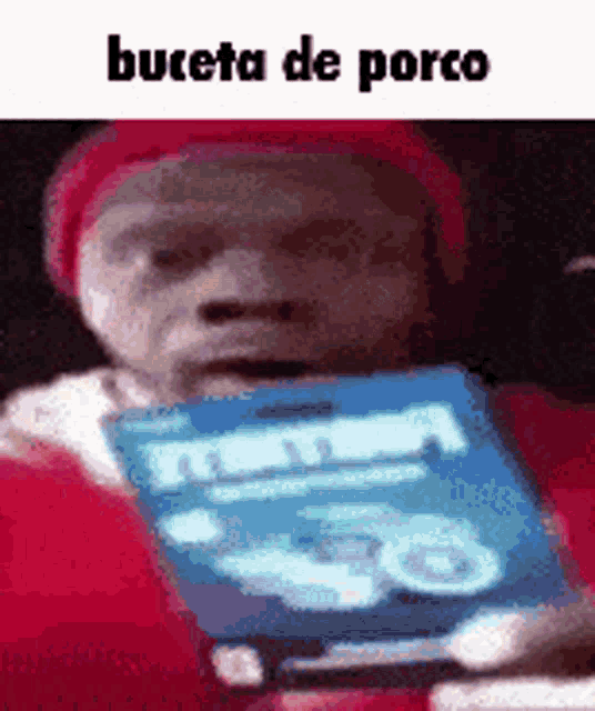a man in a red hat is holding a blue box of ritz crackers .