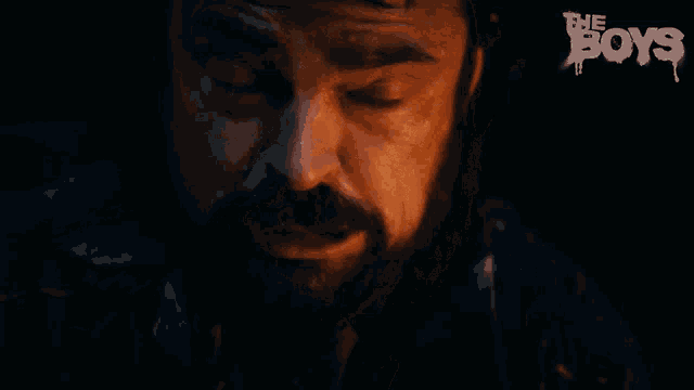 a close up of a man 's face with glowing eyes and the words the boys on the bottom