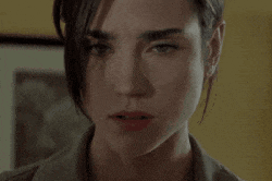 a close up of a woman 's face with a yellow background and a picture in the background .
