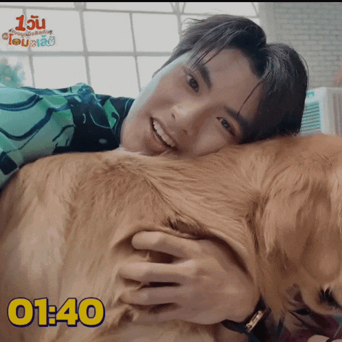 a man laying on top of a dog with the time 01:40