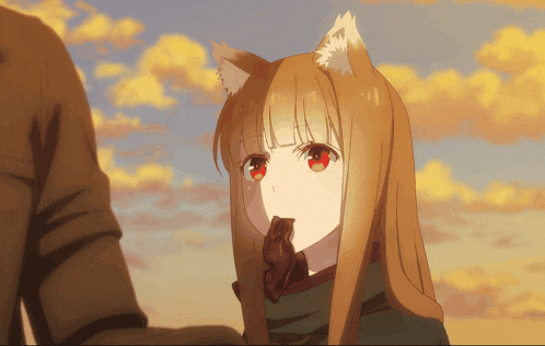 a girl with a fox ear is holding a piece of chocolate in her mouth