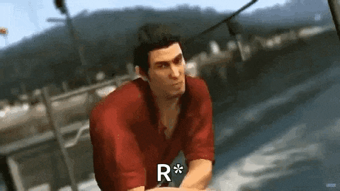 a man in a red shirt is sitting on a boat with the letter r on his chest .