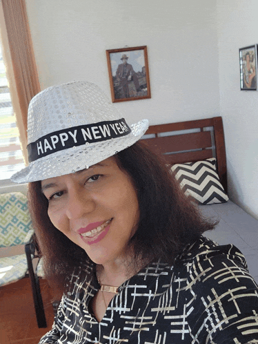 a woman wearing a hat that says " happy new year "