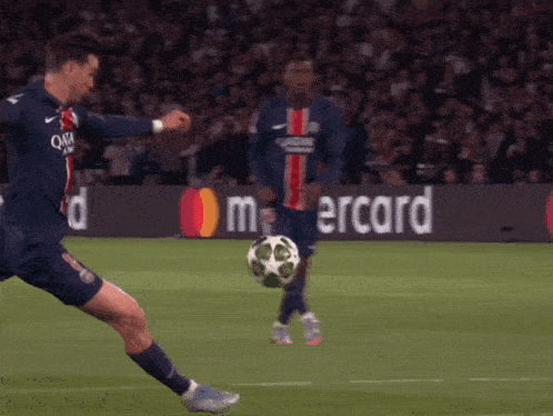 a soccer player wearing a qatar airways jersey kicks the ball