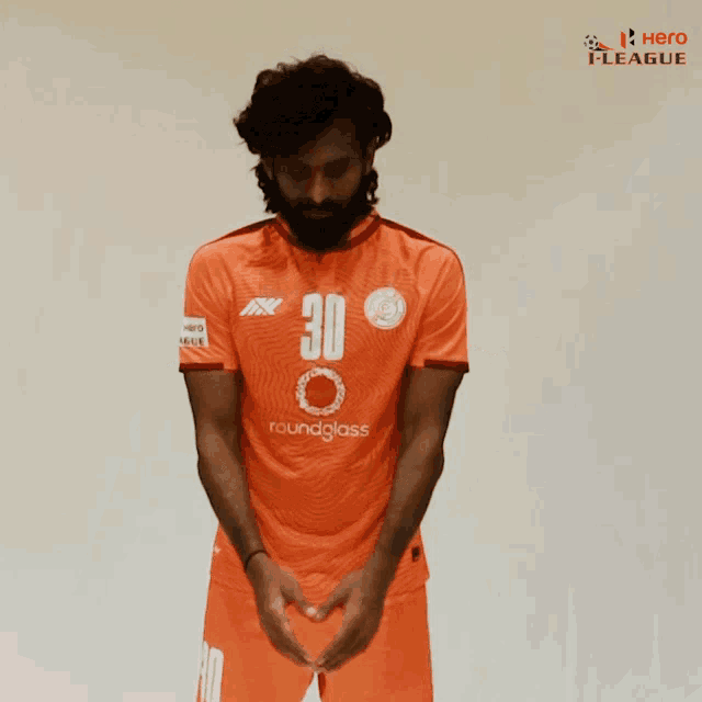 a man with a beard wearing an orange jersey with the number 30 on it
