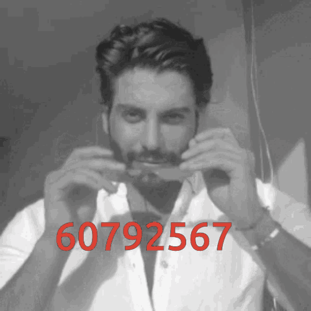 a black and white photo of a man with the number 607925667 on the bottom