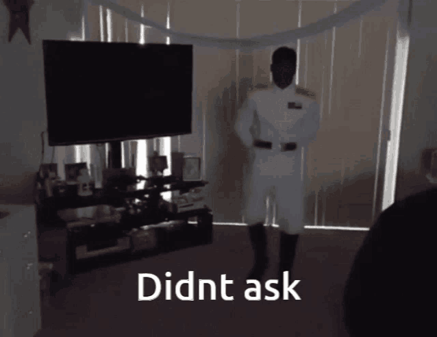 a man in a military uniform is dancing in front of a television with the words didnt ask written below him