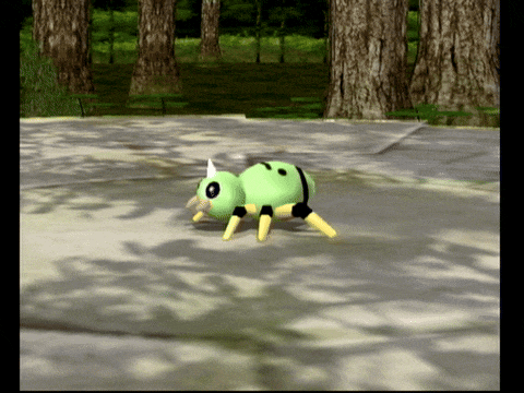 a green and yellow cartoon spider is walking on a concrete surface