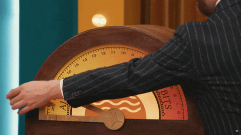 a man in a suit is playing a game with a clock that says bits