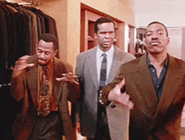 three men in suits and ties are dancing in a room