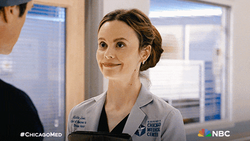 a woman in a chicago medical center coat smiles
