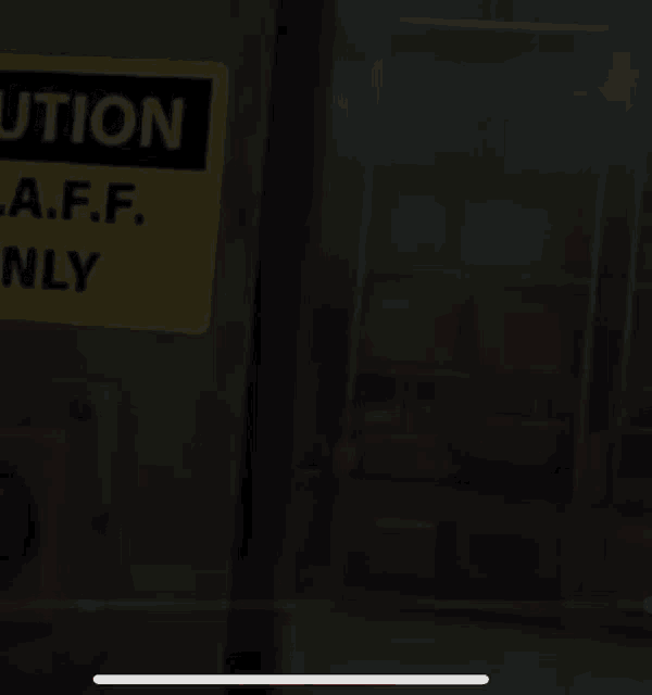 a yellow sign on a door says caution a.f.f. only .