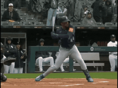 a baseball player is swinging at a pitch in front of a wall that says milwaukee astros