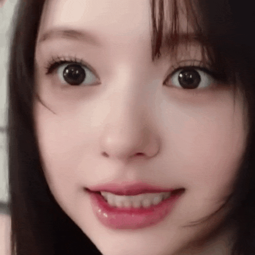 a close up of a woman 's face with her mouth open and her eyes closed .