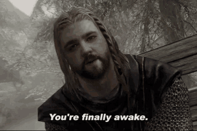a man with dreadlocks and a beard says " you 're finally awake "