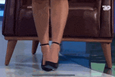 a woman is sitting in a chair with her legs crossed
