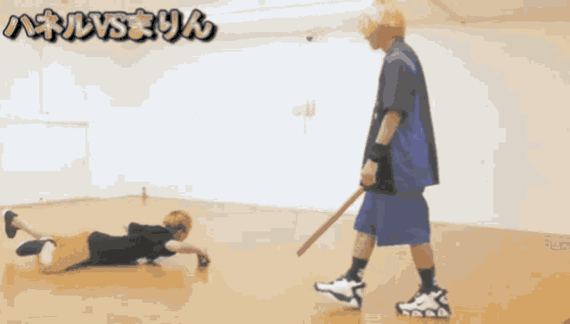 a man holding a baseball bat stands next to a man laying on the floor with the words " vs " above them