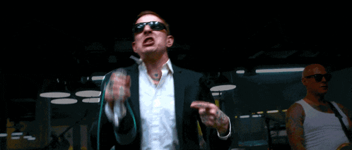 a man singing into a microphone with the words i said all i got is the back and my never ending hate for