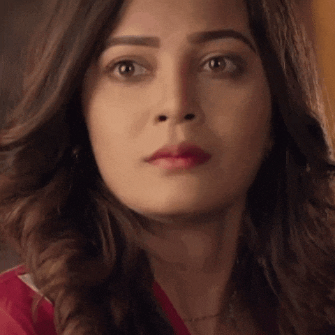 a close up of a woman 's face with a serious look on her face