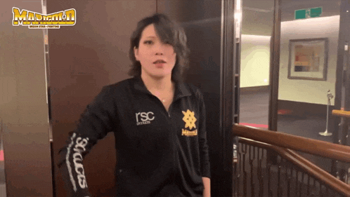 a woman wearing a black shirt that says rsc on the front