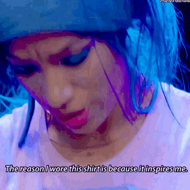 a woman with blue hair says the reason she wore this shirt is because it inspires her
