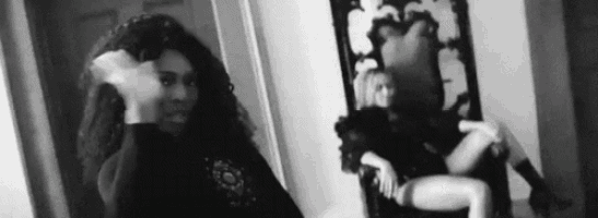a woman is standing in front of a mirror in a room .