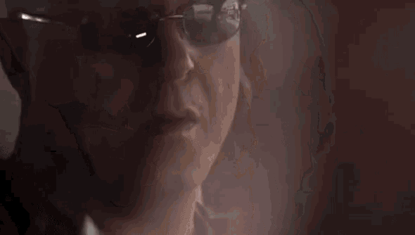 a man wearing sunglasses is talking on a cellphone