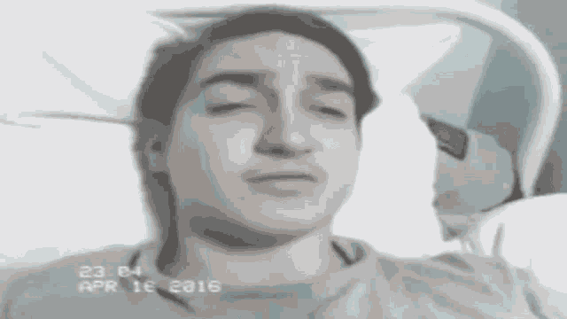 a black and white photo of a man in a hospital bed with the date april 16 2016