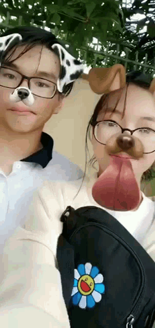 a boy and a girl wearing dog ears and glasses .