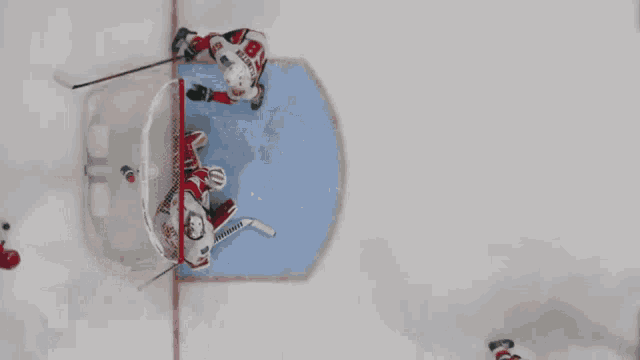 a hockey player with the number 14 on his jersey is going for the puck