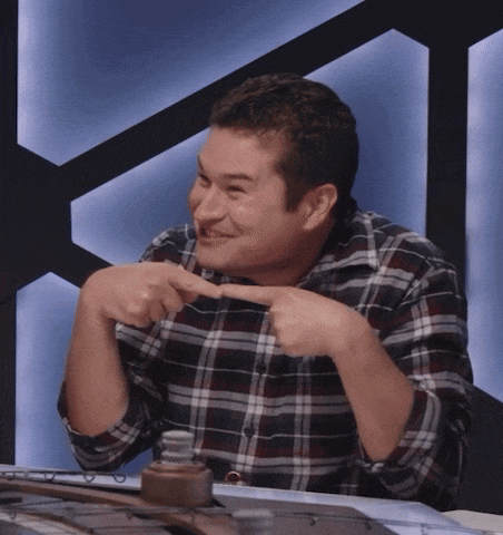 a man in a plaid shirt is pointing at something with his fingers