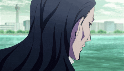 a man with long black hair looks at the water