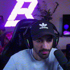 a man wearing an adidas hat and headphones is talking into a microphone