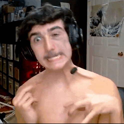 a shirtless man wearing headphones and a mustache making a funny face