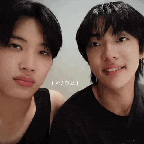 two young men are standing next to each other and one has a nose piercing