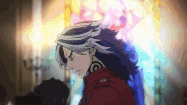 a man with long hair is praying in front of a colorful stained glass window