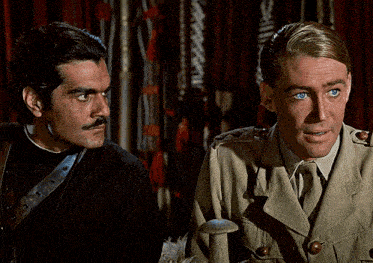 a man with a mustache is standing next to another man in a military uniform